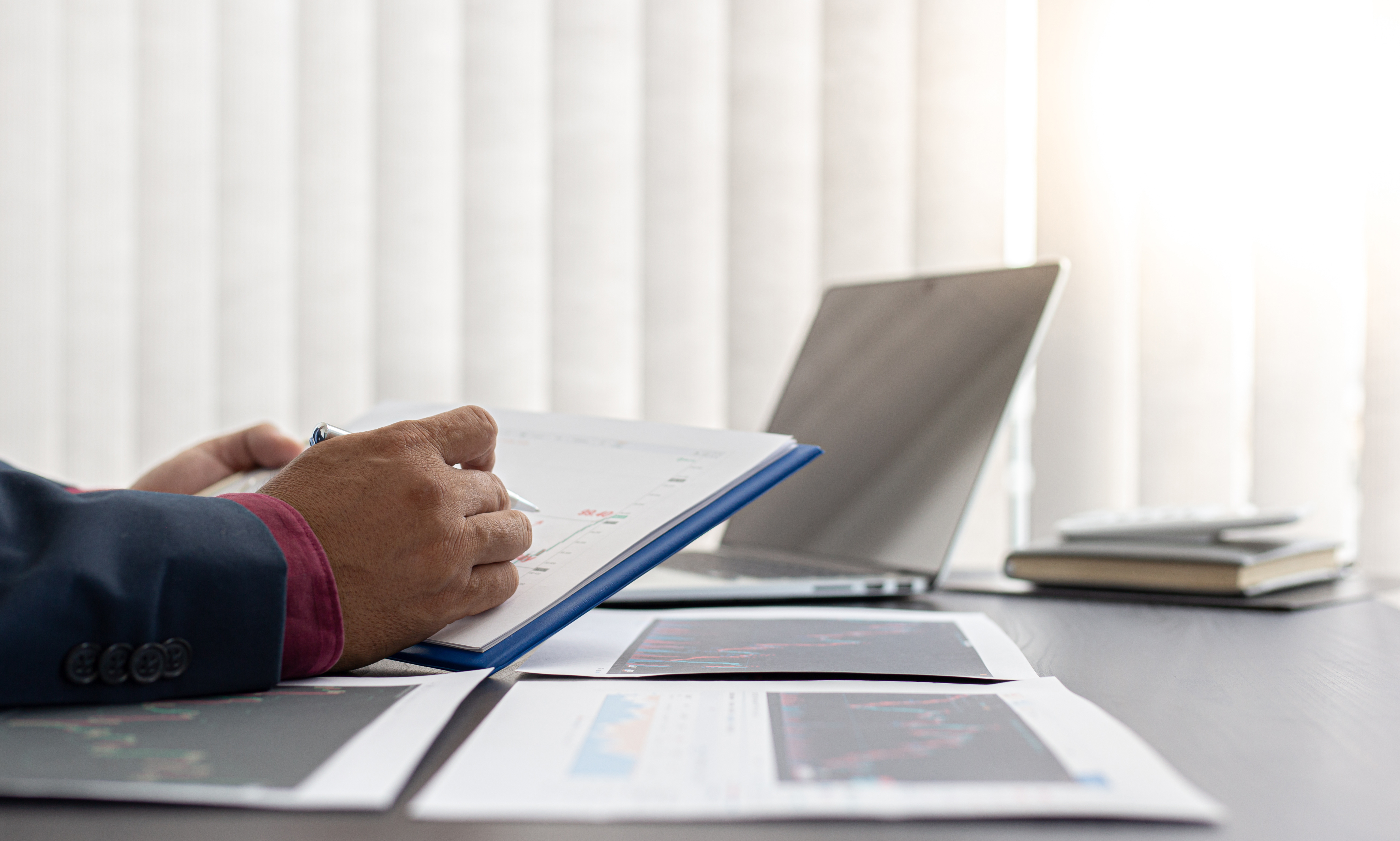 Man Analysing Reports in an Office